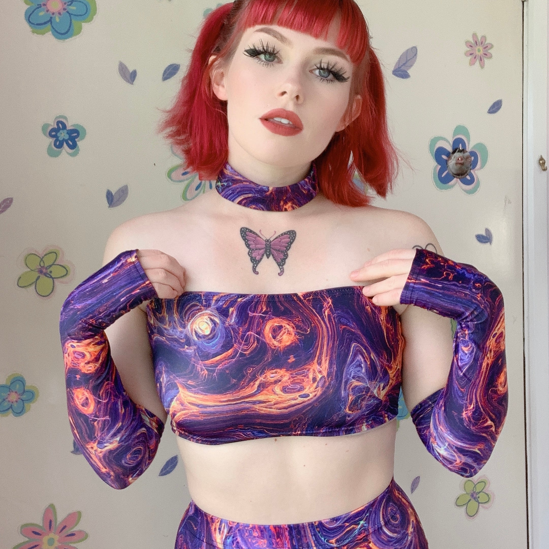 redhead girl with butterfly tattoo wearing rave outfit choker tube top with arm warmers